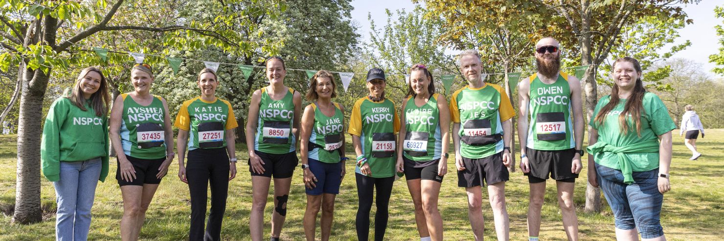 NSPCC marathoners smiling outside.