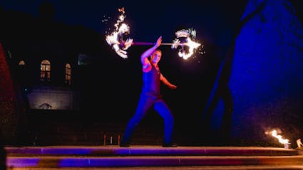 Stage show with performer and firestaff. 