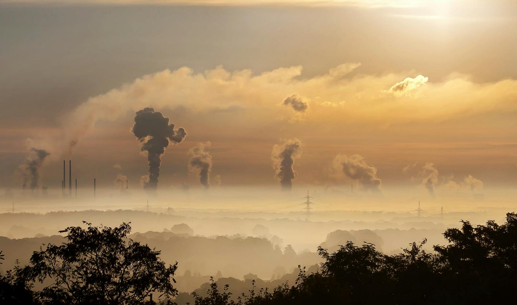 smog billowing into the air from towers