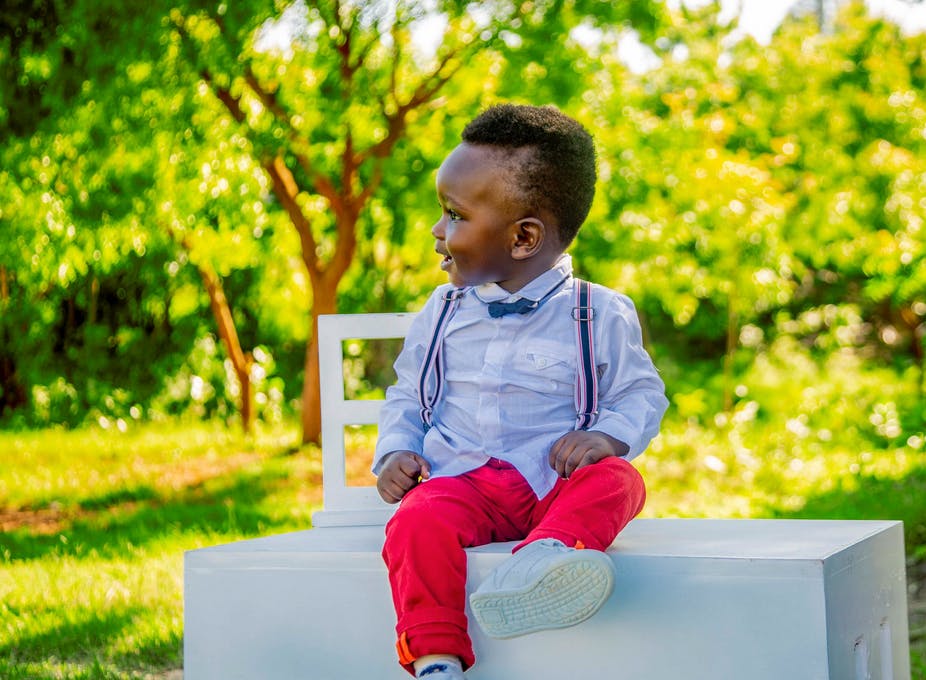 toddler sitting on a block ready for a professional photo