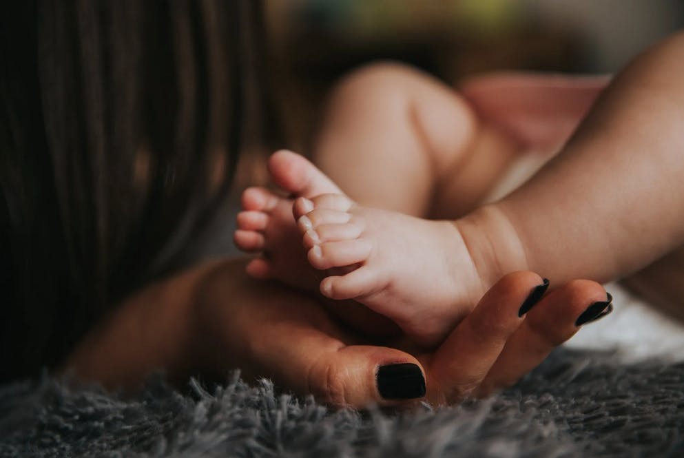 mom holding baby's foot