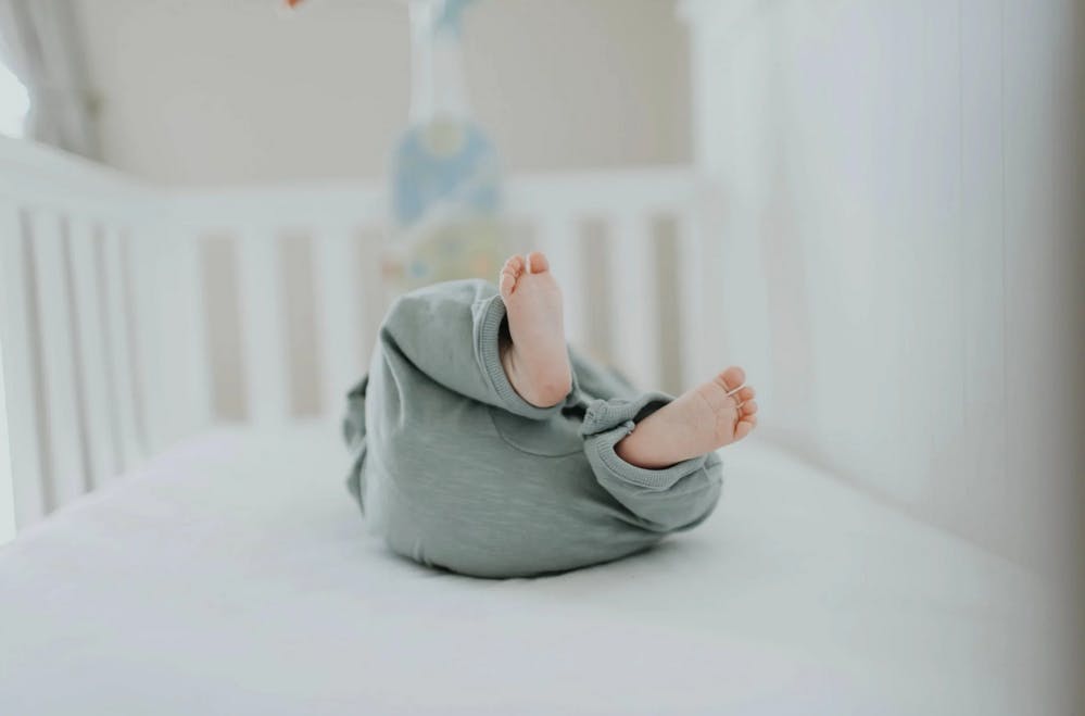 a baby laying down in a crib