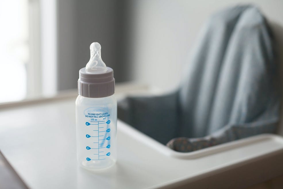bottle on high chair ready for baby to drink