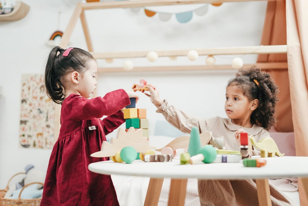 two girls playing with blocks