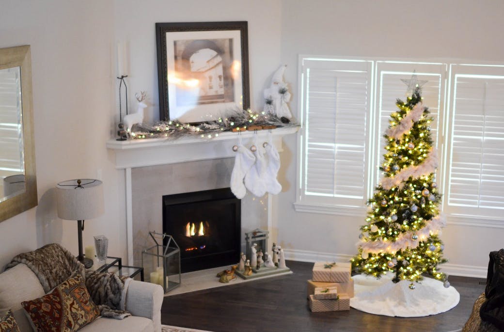 living room with christmas tree and fireplace