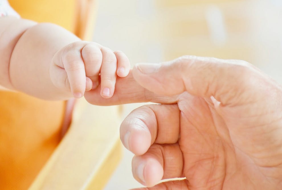 mom and baby holding hands