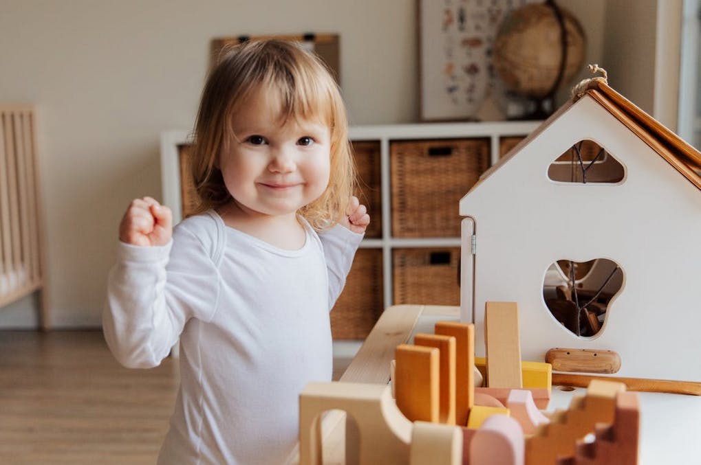 baby playing with toys doing sign language