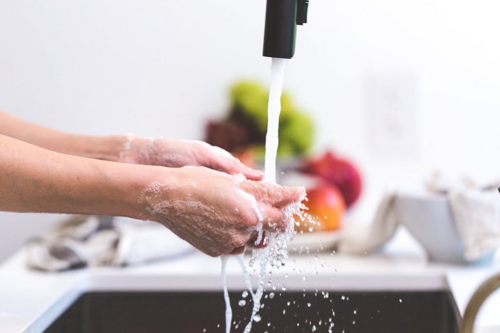 parent washing hands before cleaning toys