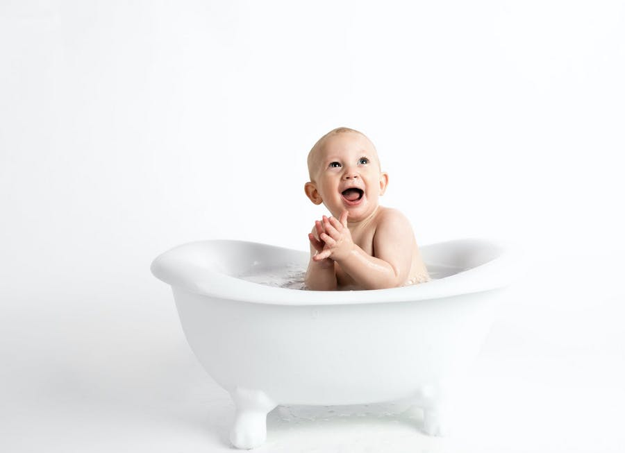 baby in bath clapping
