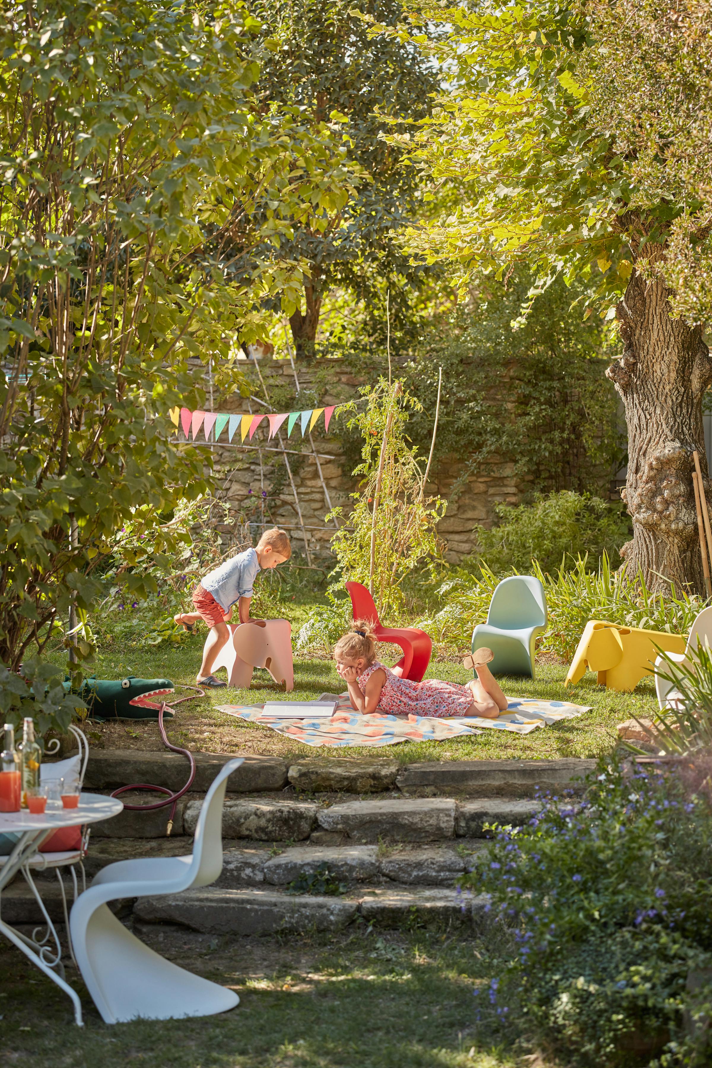 Children playing in the garden with Panton children's chairs and an Eames elephant