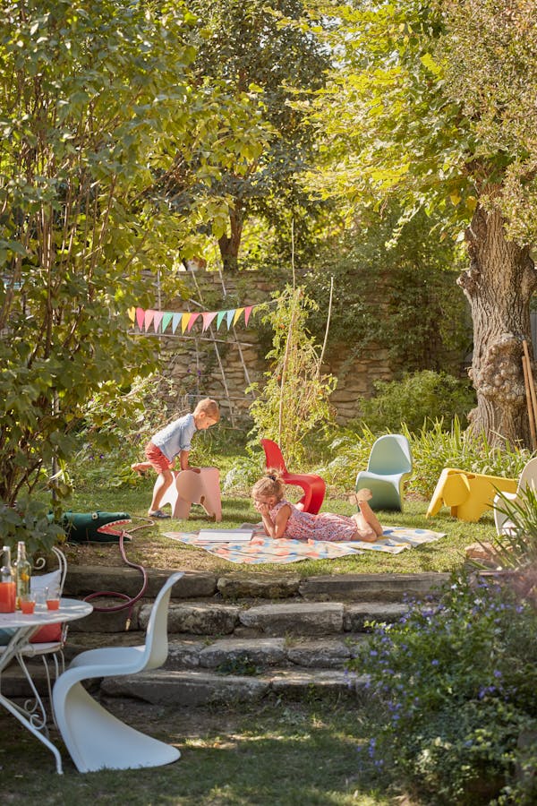 Children playing in the garden with Panton children's chairs and an Eames elephant