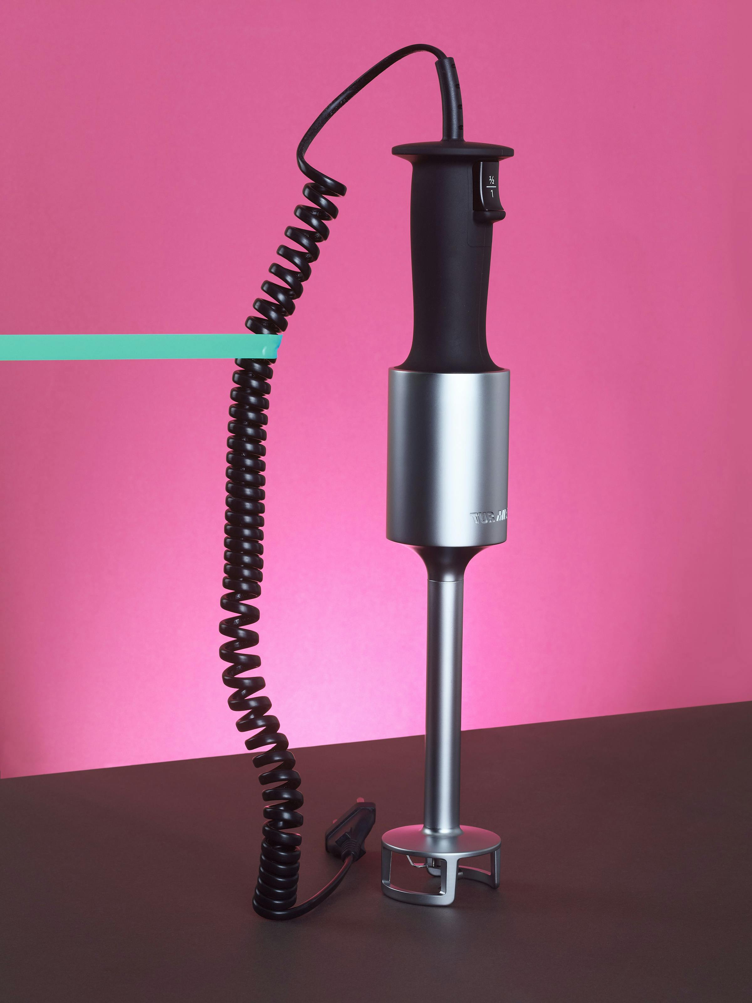 A purging stick by TurMix in front of a pink background