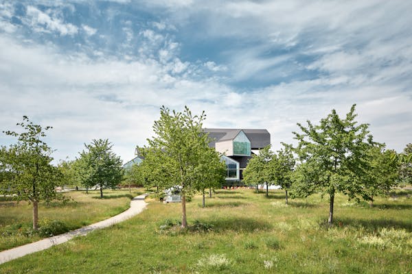Architectural photograph of the Vitra House with fruit trees in front of it