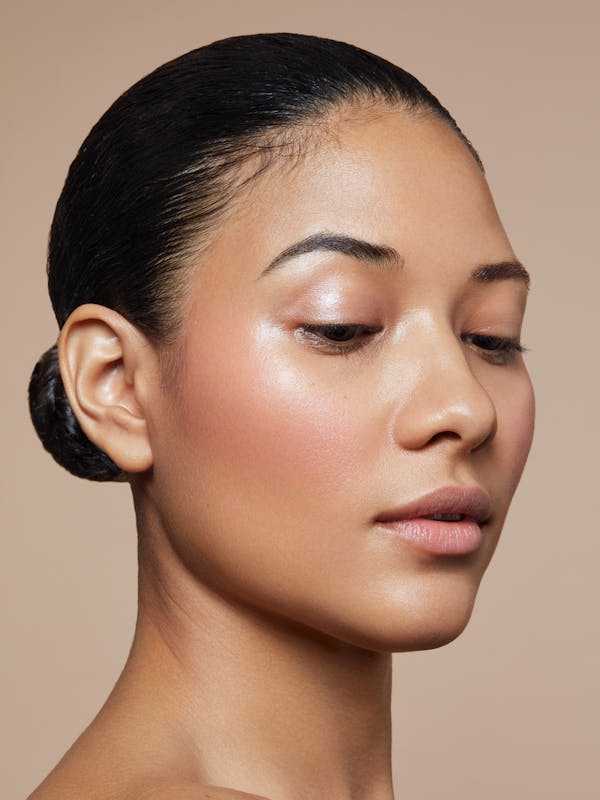Beauty shot of a young woman with her black hair pulled back tightly