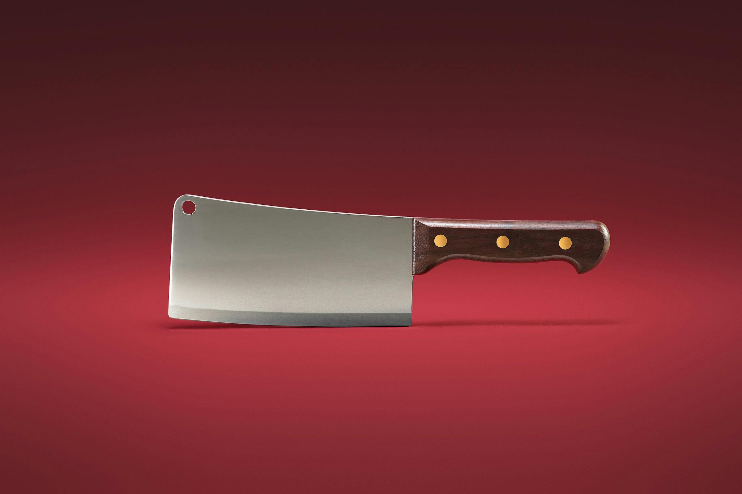 Packshot of a meat cleaver on a red background