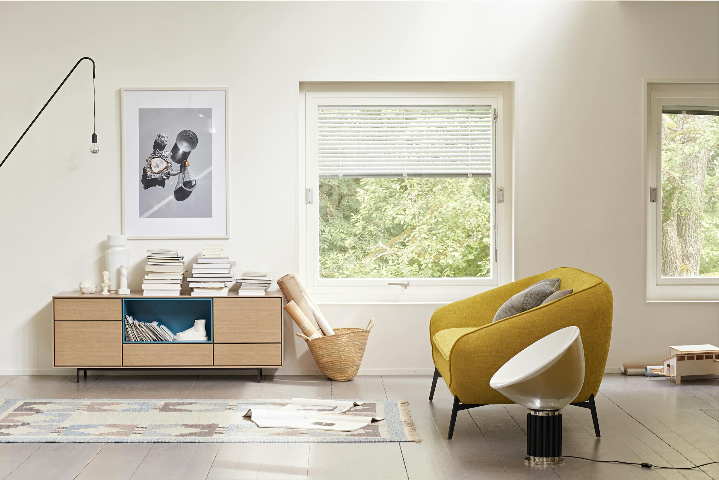 Yellow sofa with sideboard and lots of books in a living room