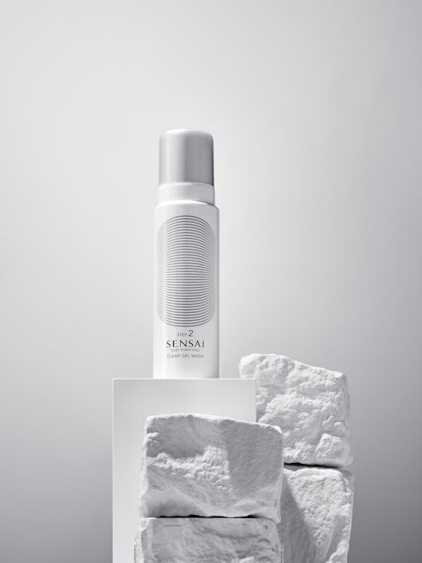 White beauty product on white painted stones