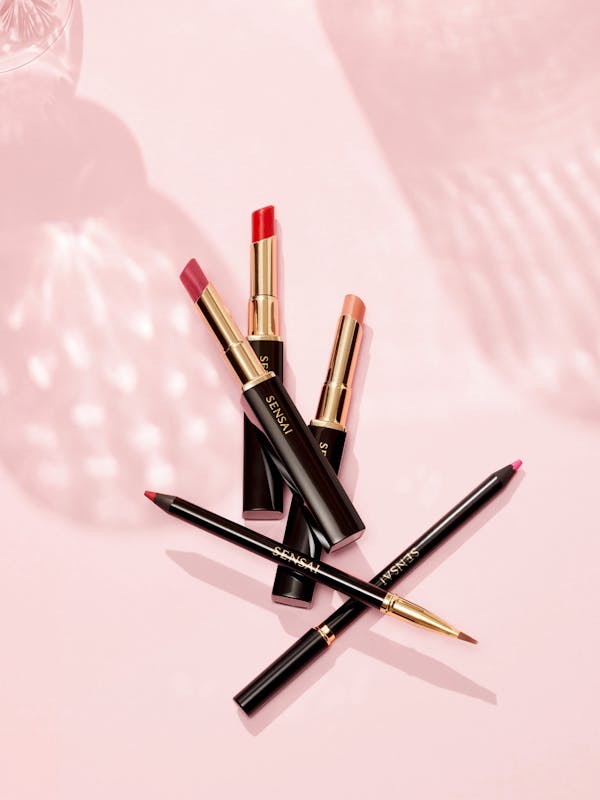 Lipsticks on a light pink background