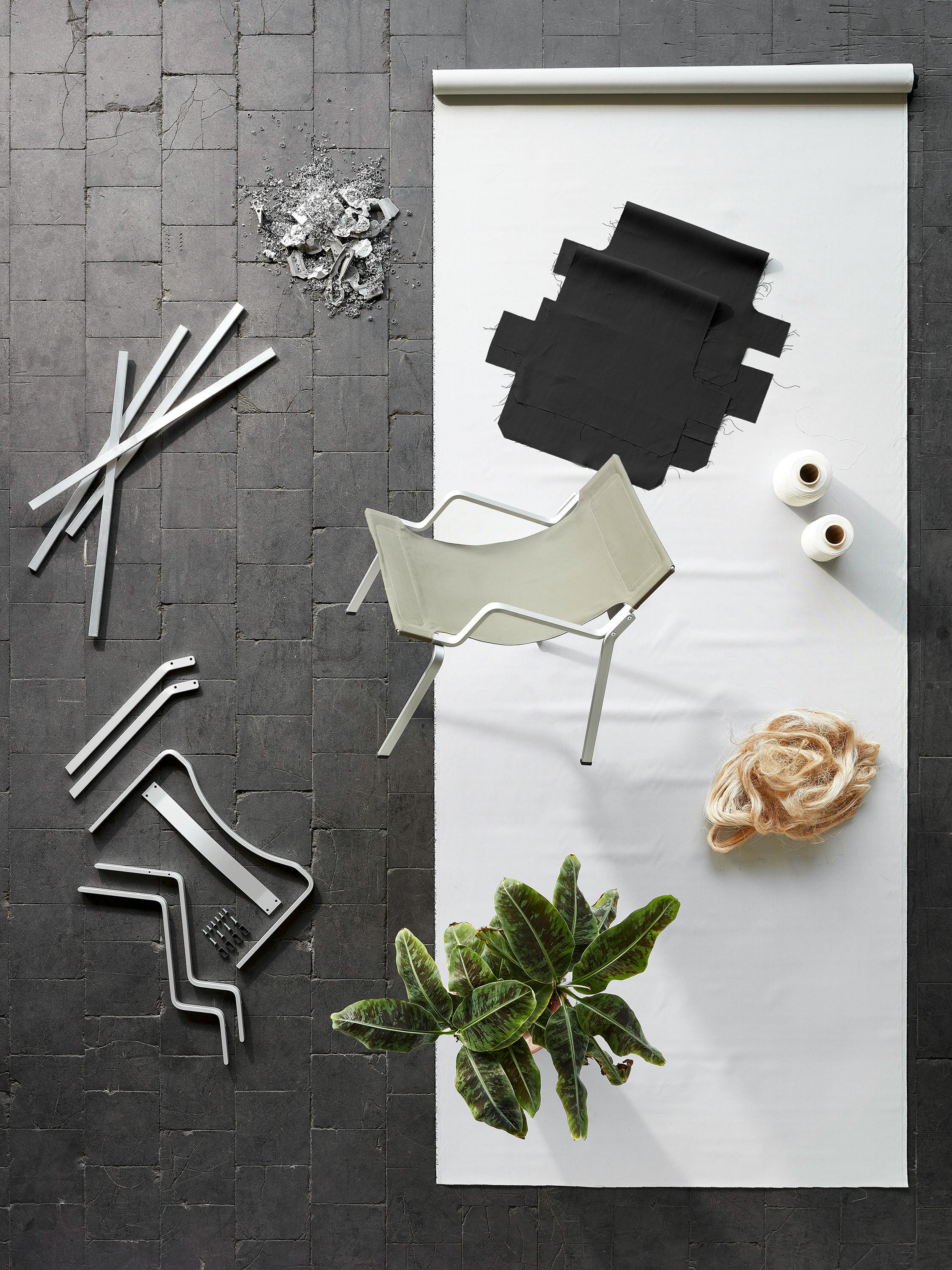 Enso chair by Frédéric Dedelley surrounded by his fabric, yarn, banana plant and aluminium profiles