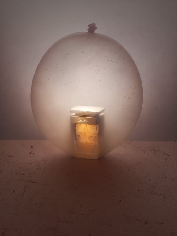 a Cartier perfume in a large nude-coloured balloon