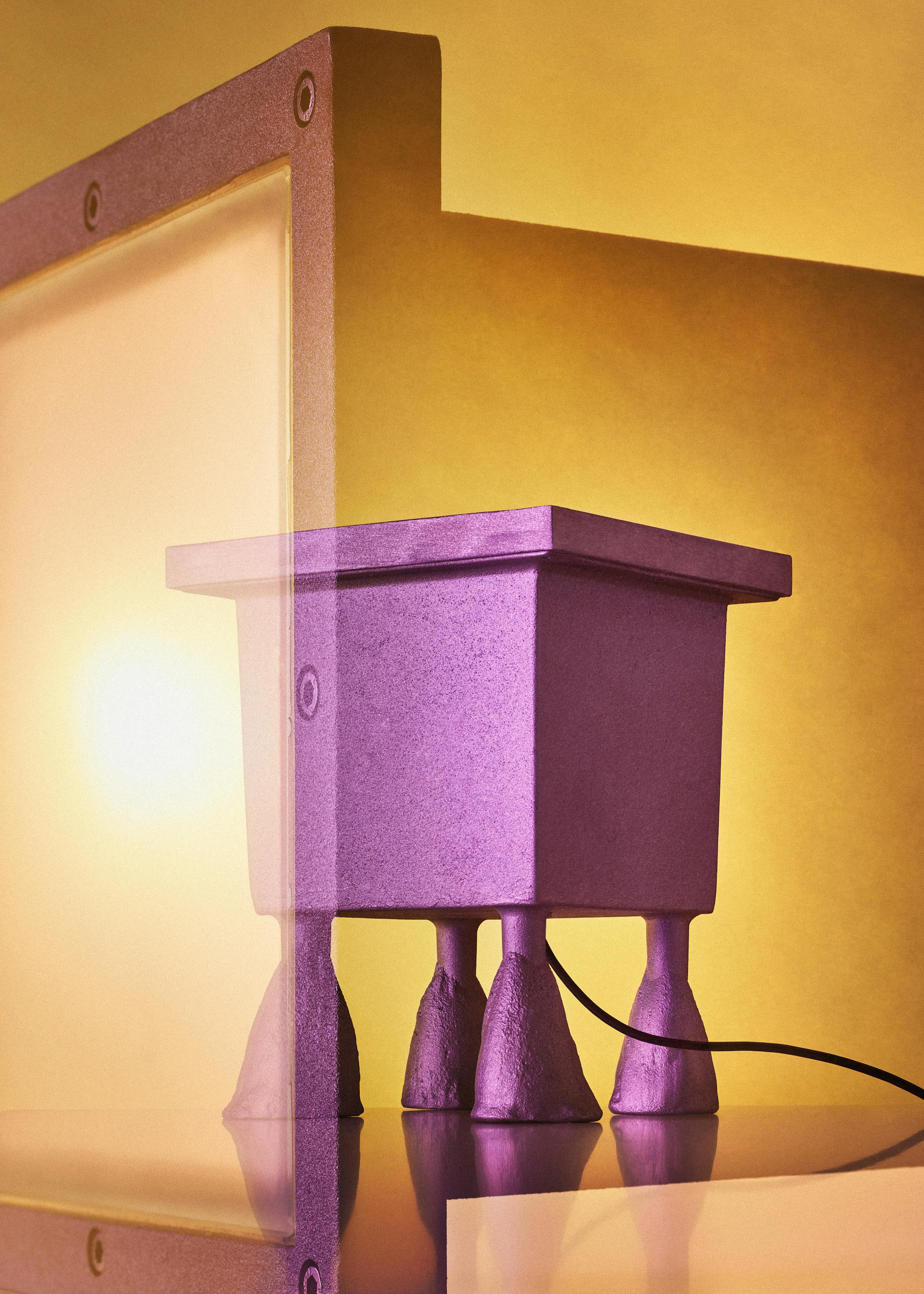 Multiple analogue exposure of the floor lamp "Big feet" by Italiand designer Mario Nanni in fornt of a vibrant yellow background