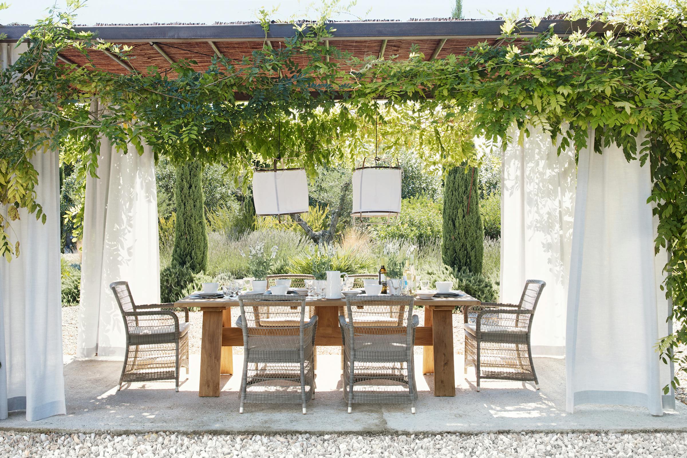 Outdoor dining table set for lunch in the shade of a pergola