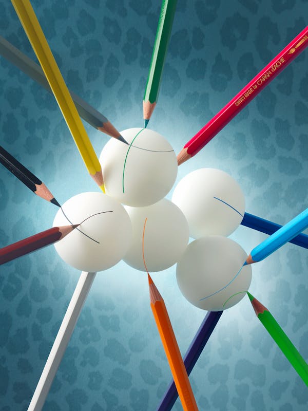 Coloured pencils that balance and mark many ping-pong balls in the shape of clouds