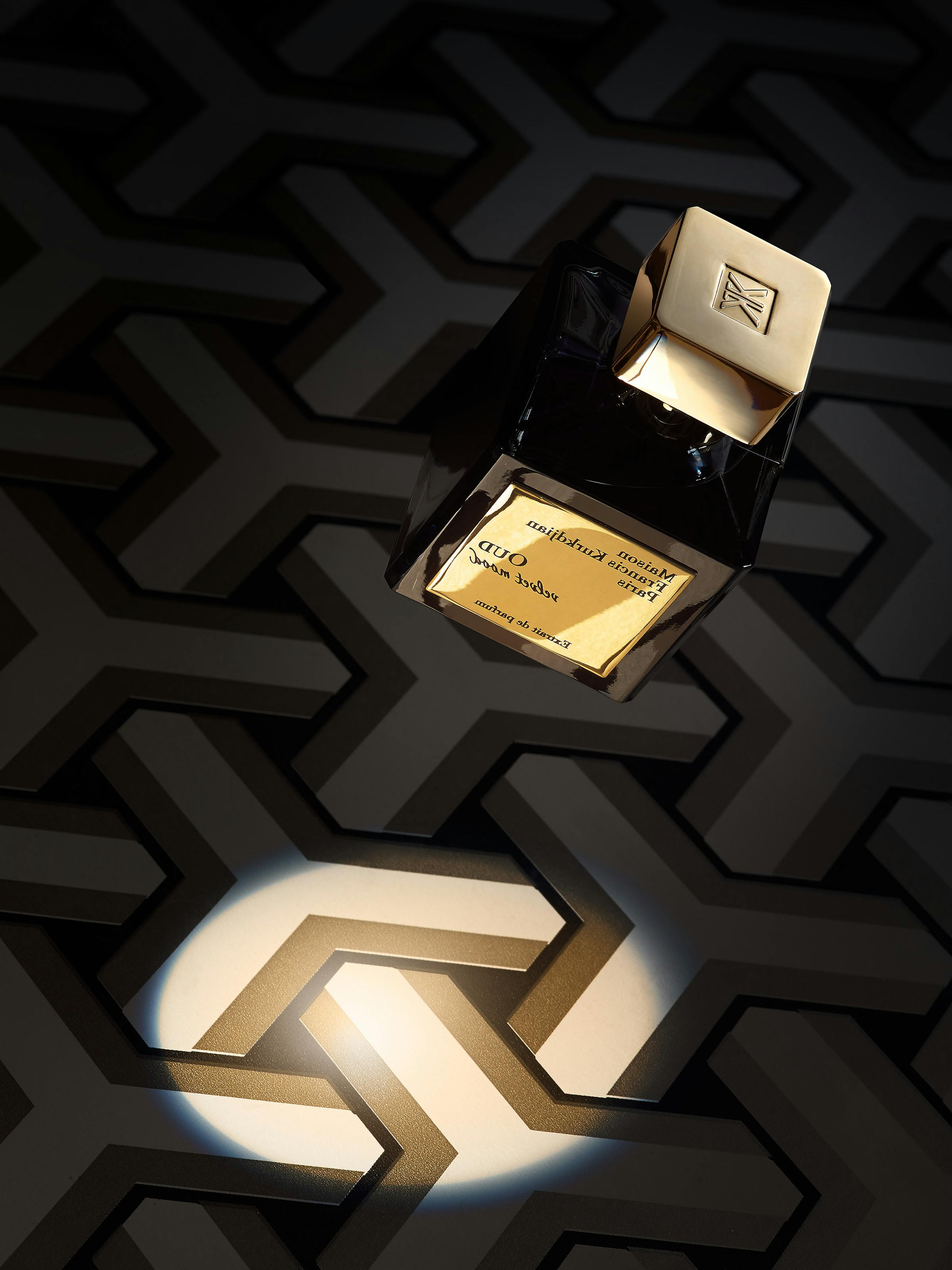 A floating perfume bottle against a black graphic background