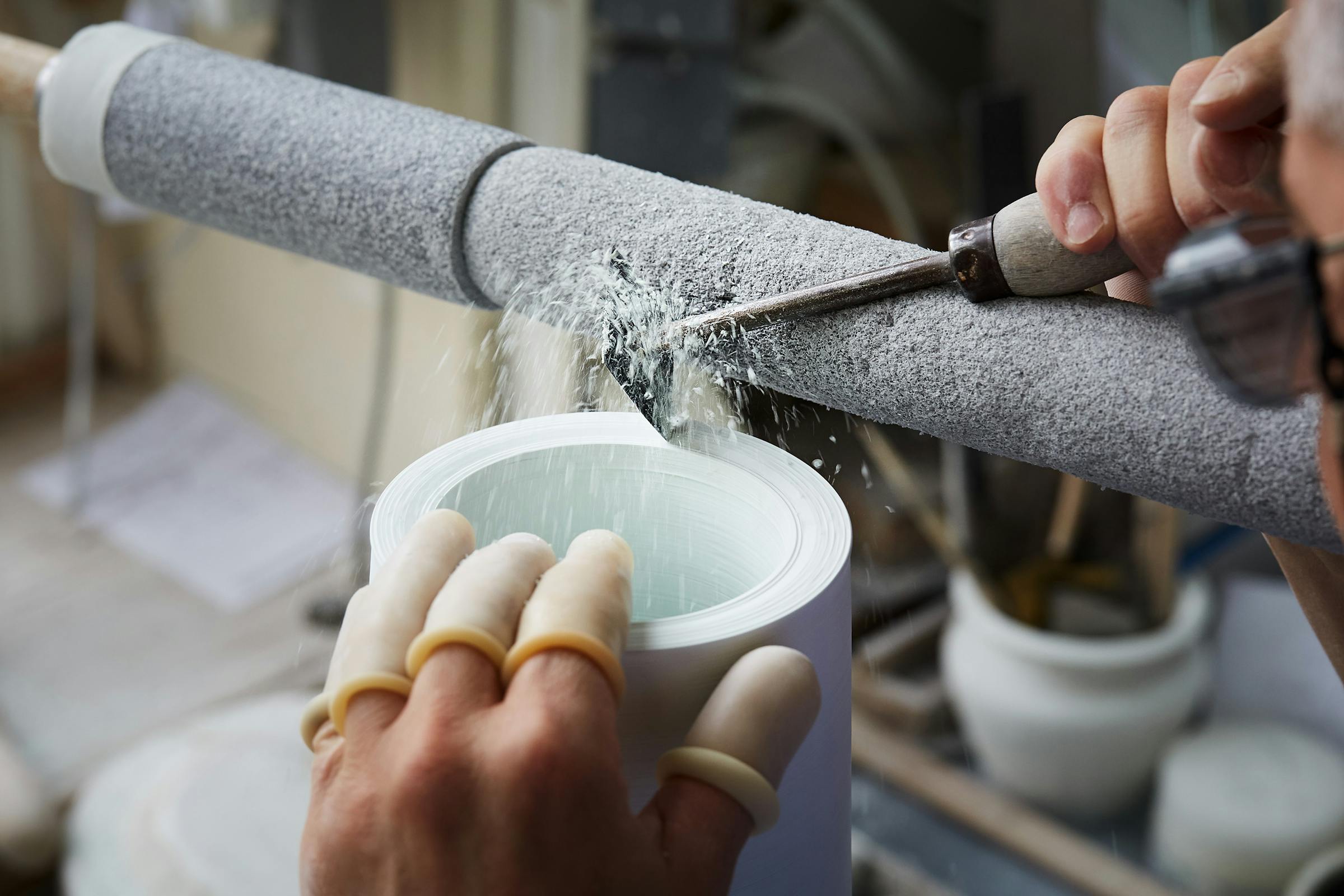 A craftsman turning a porcelain vessel