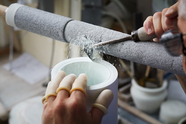 A craftsman turning a porcelain vessel