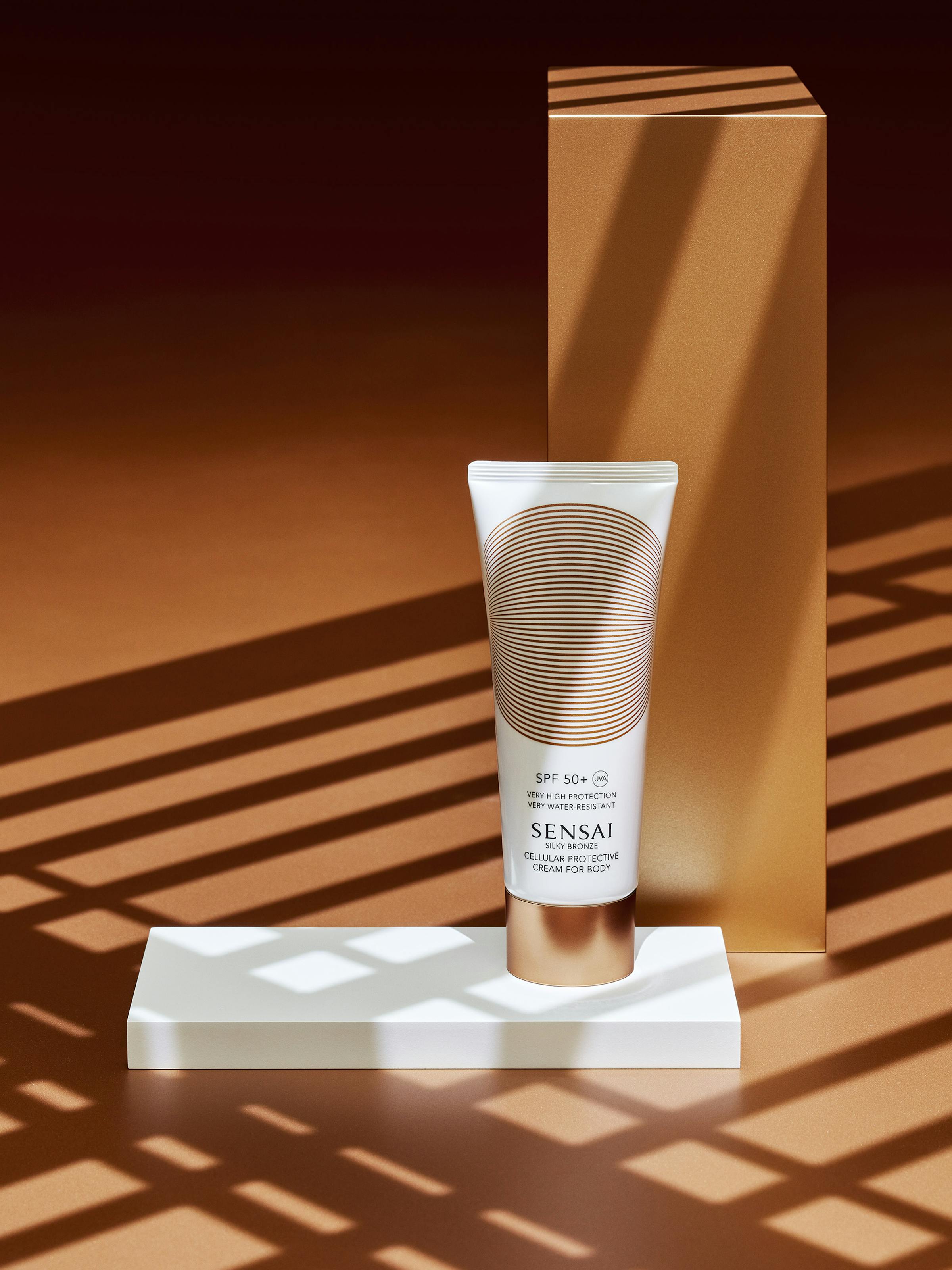 Sunscreen tube on a bronze background with sharp graphic shadows