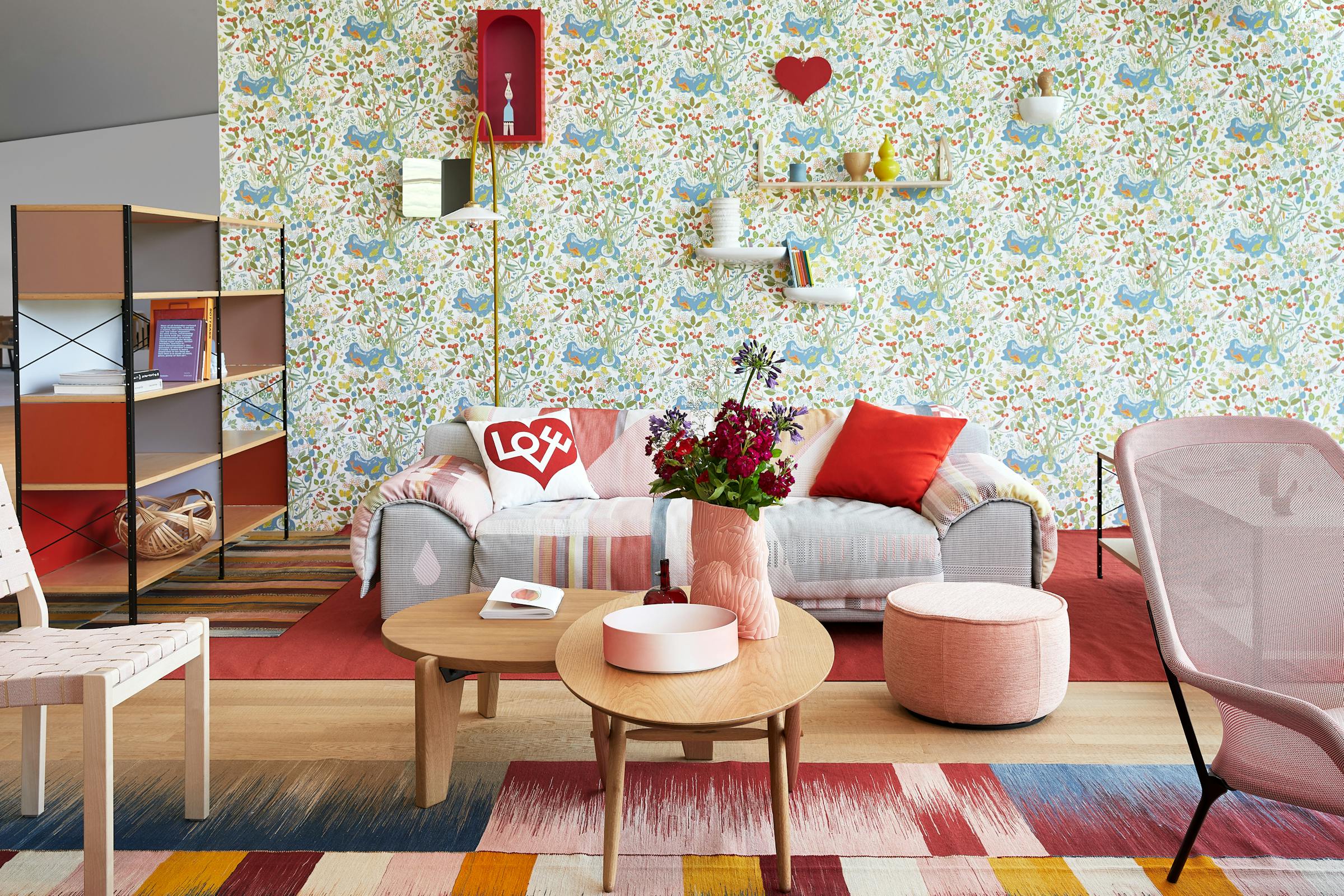 Sofa on a red carpet with floral wallpaper in the Vitra House