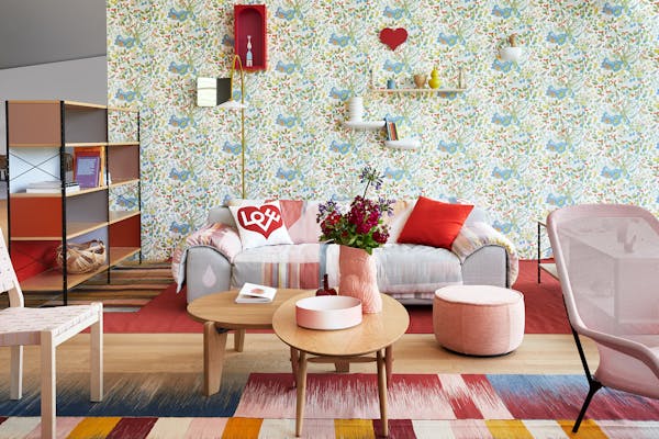 Sofa on a red carpet with floral wallpaper in the Vitra House