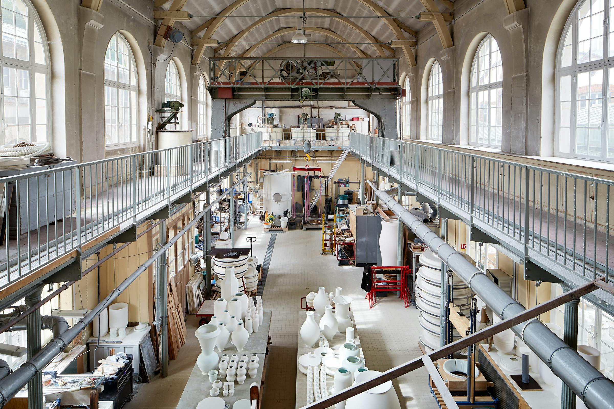 Interior view of the Sévres porcelain factory with large unfired vases made from tables