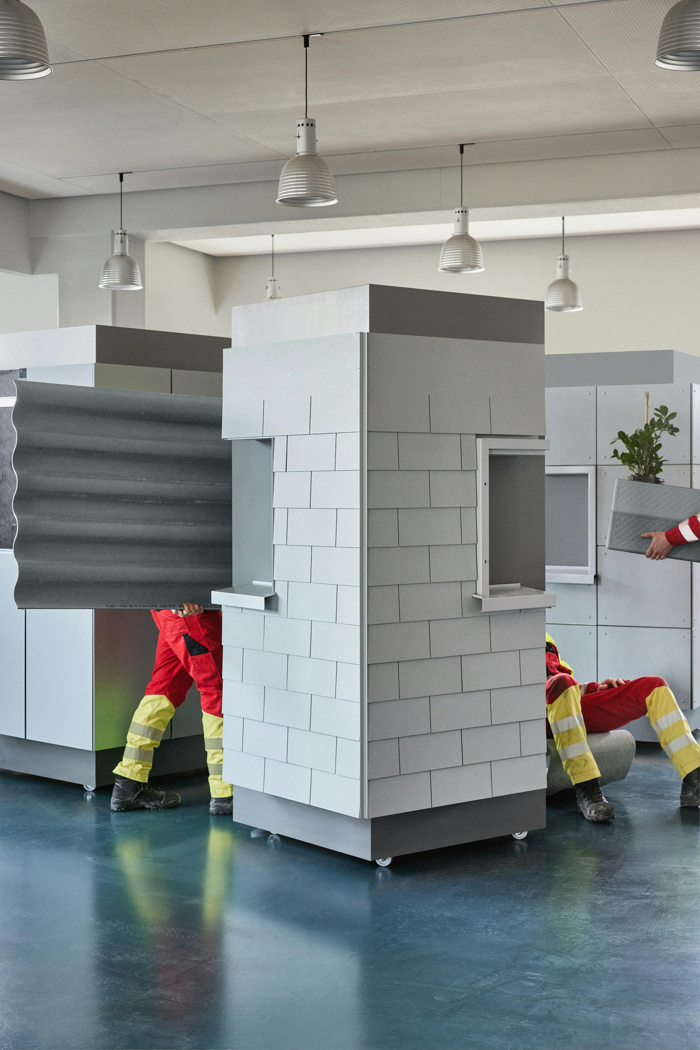 three workes carrying eternit products in the showroom of the company