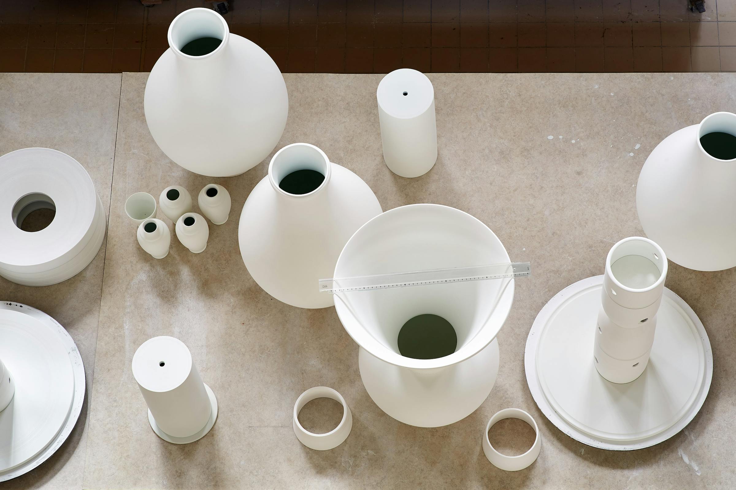 Table display with large white unfired porcelain objects
