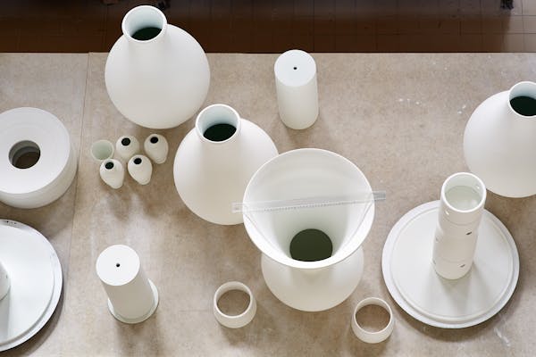 Table display with large white unfired porcelain objects