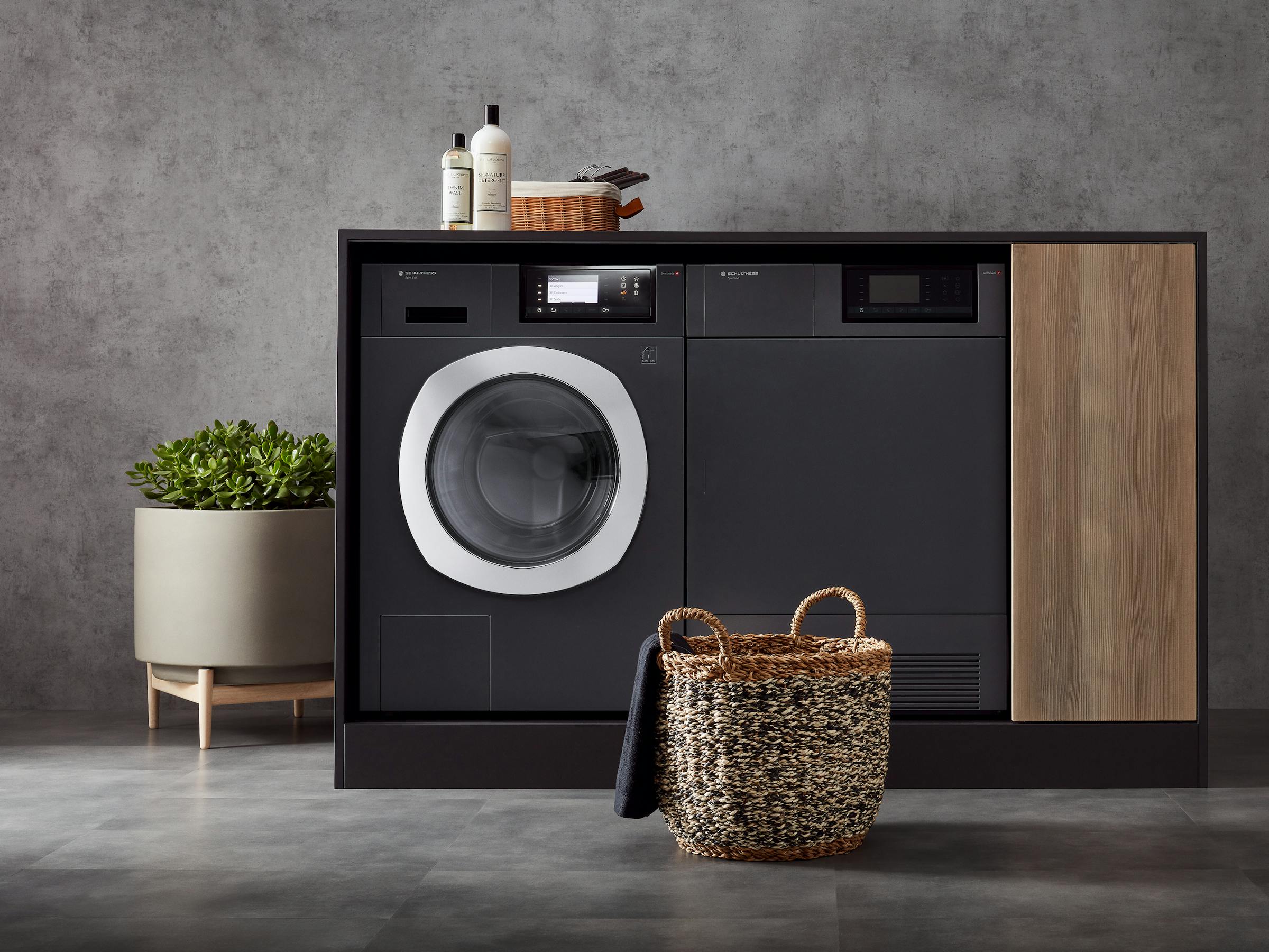 Washing machine and tumble dryer in a built-in cupboard with washing accessories