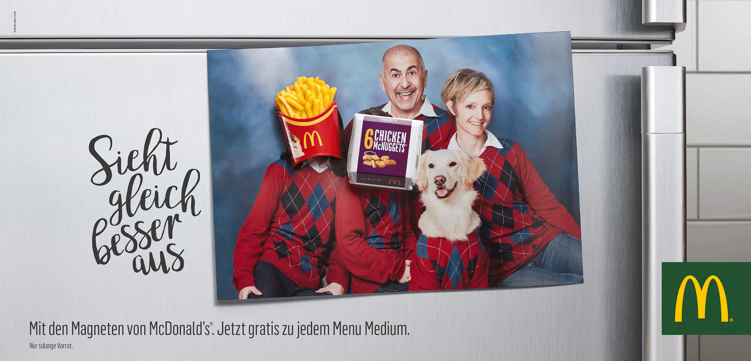 Postcard on a fridge with two magnets in the shape of a burger and french fries