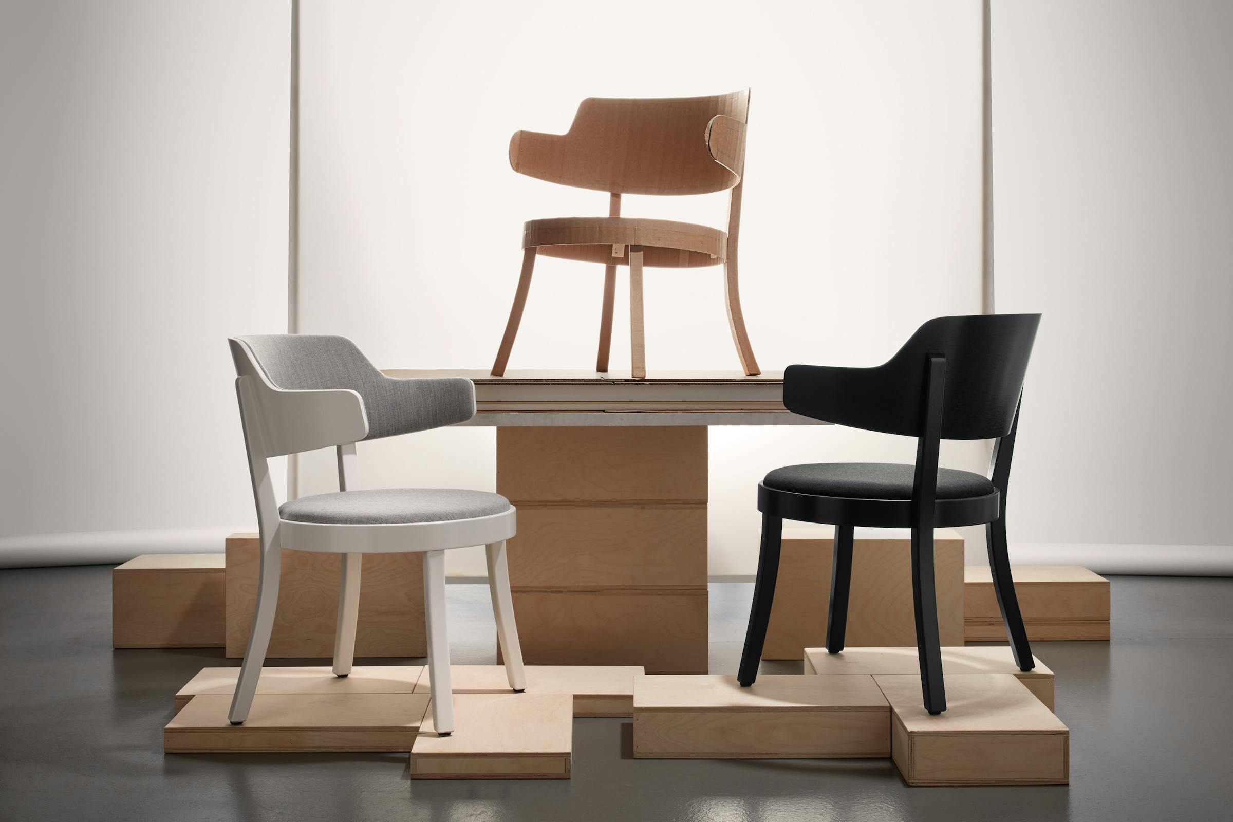 Three versions of the Seley armchair by Frédéric Dedelley for HorgenGlarus against a white background