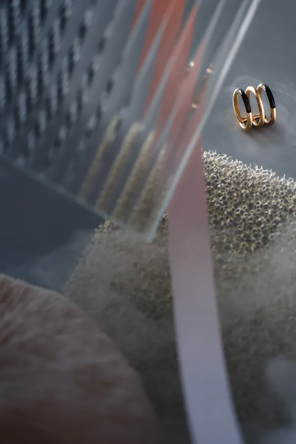 Finger ring with ribbed glass on a grey background