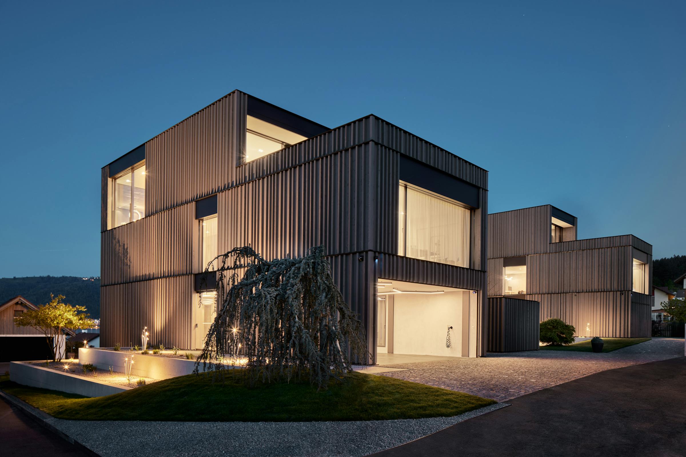 Exterior view of a cubist villa at dusk