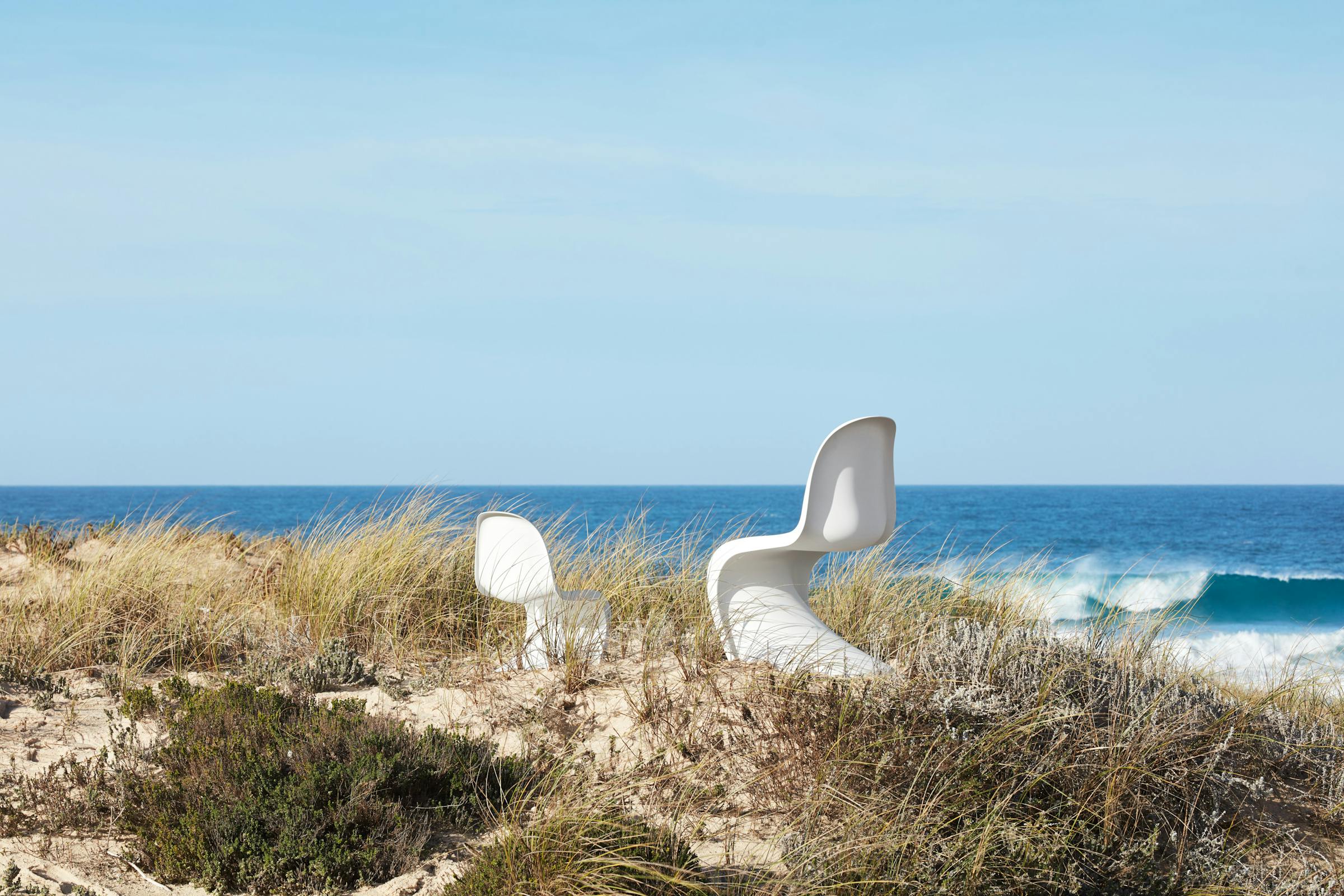 A children's and an adult Panton Chair in the dunes overlooking the sea