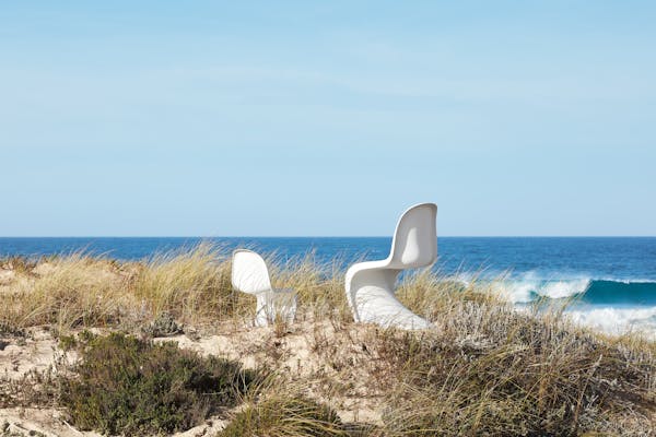 A children's and an adult Panton Chair in the dunes overlooking the sea