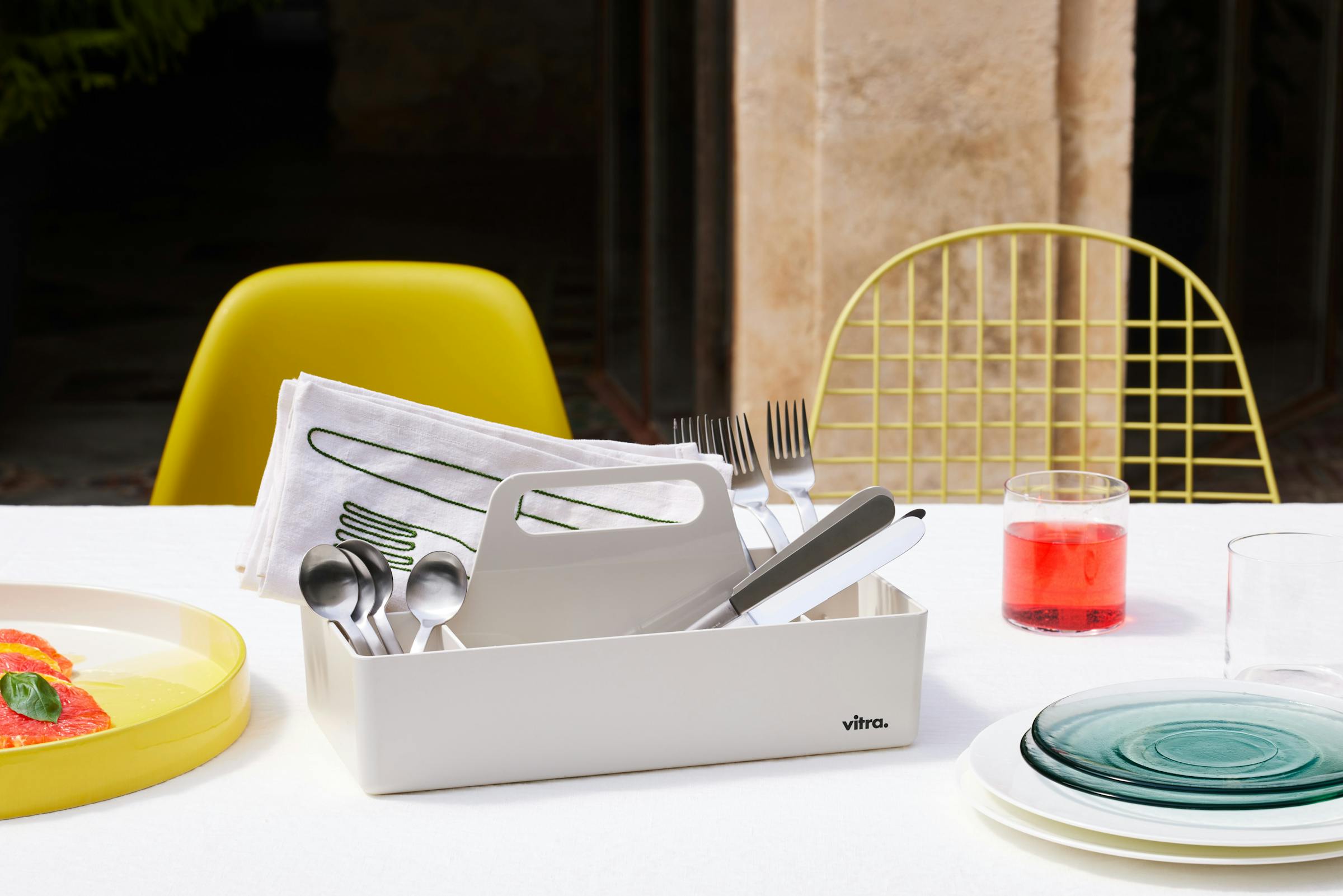 Table with yellow ceramic top and cutlery 