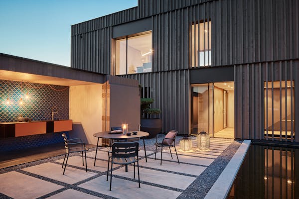 Inner courtyard at dusk with an outdoor table and four chairs