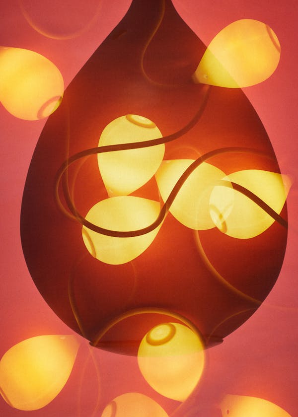 Multiple analoge exposure of the lamp Jingzi by Swiss architects Herzog & DeMeuron in front of a red background