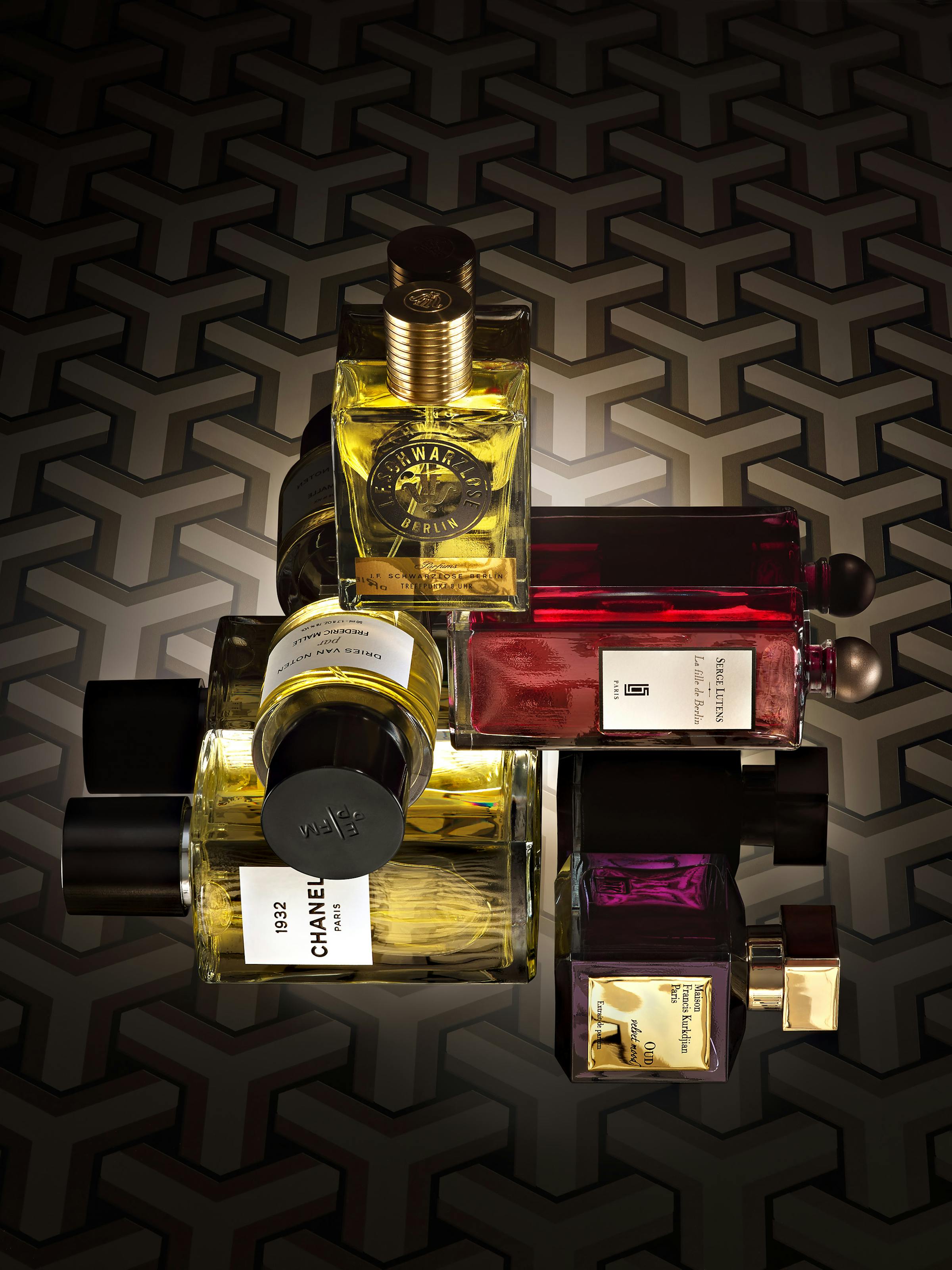 Group of 5 perfumes on a black graphic background