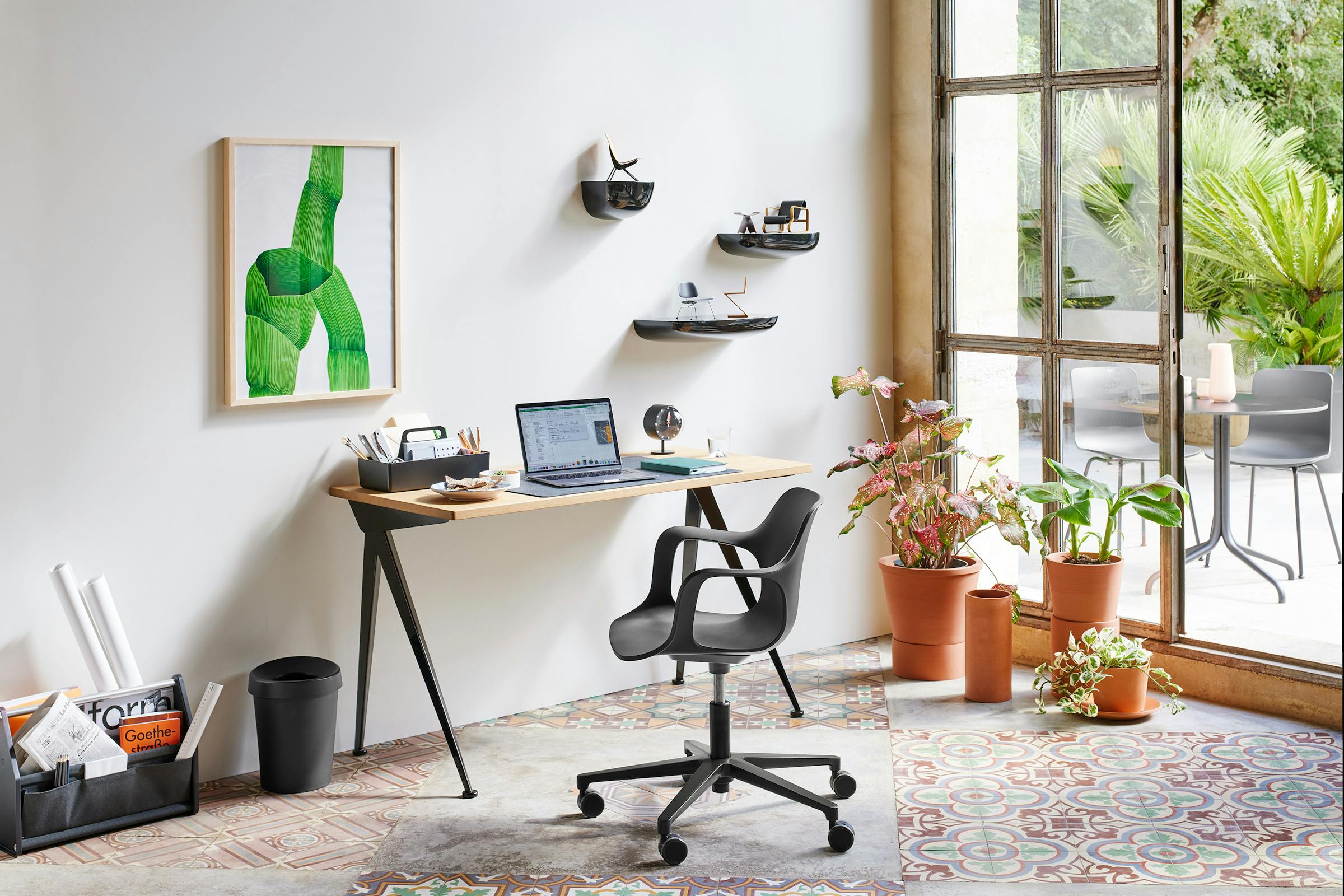 Home office in a building in the south of France with plant pots and a Ronan Bouroullec painting