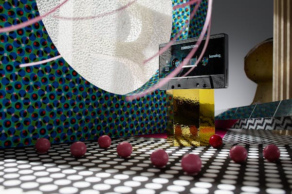 Cassette on a golden pedestal in a fantastic set design with blue pattern and pink balls